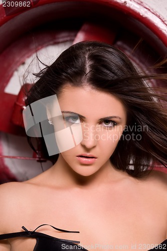 Image of woman in black lingerie with big red fan