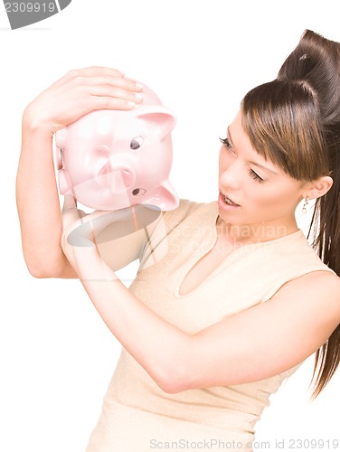 Image of lovely woman with piggy bank