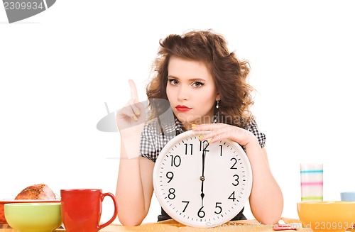 Image of young attractive woman in the kitchen