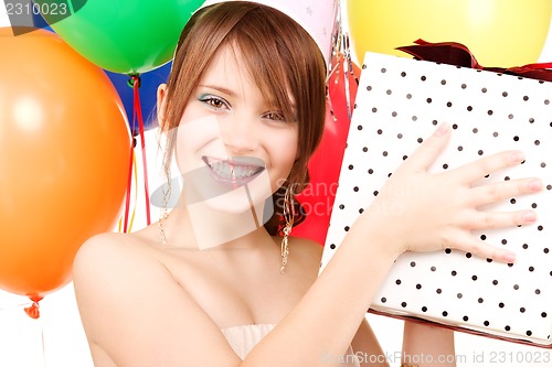 Image of party girl with balloons and gift box