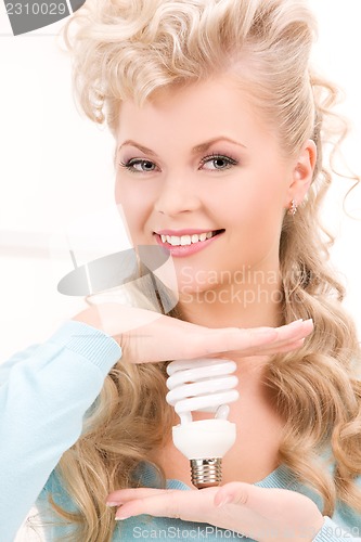 Image of woman holding energy saving bulb