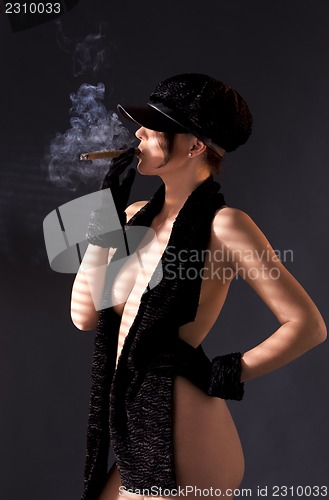 Image of woman in black astrakhan smoking cigar