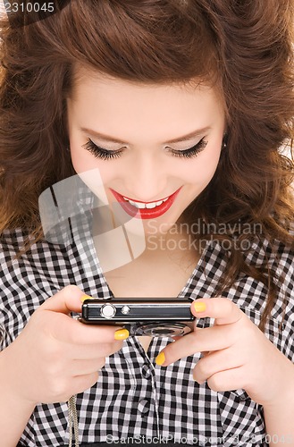 Image of happy teenage girl with digital camera