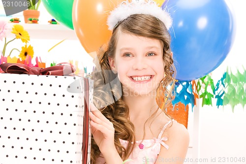 Image of party girl with balloons and gift box