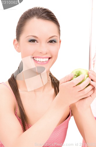 Image of young beautiful woman with green apple