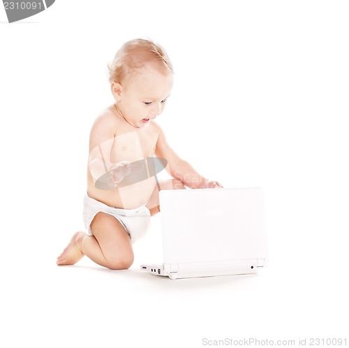 Image of baby boy in diaper with laptop computer
