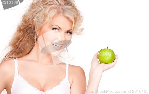Image of young beautiful woman with green apple