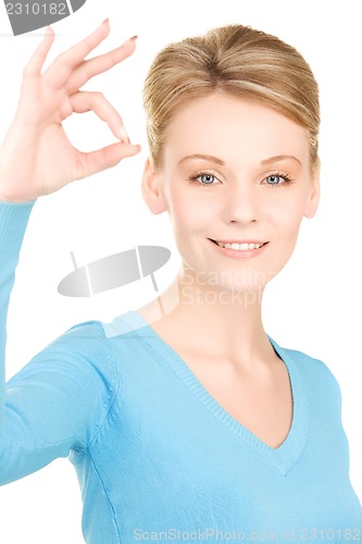 Image of lovely woman showing ok sign