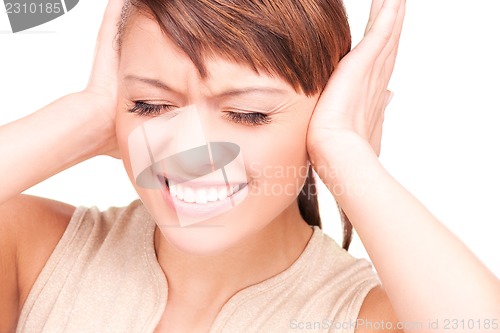 Image of unhappy woman with hands on ears