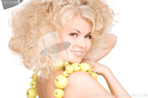 Image of happy woman with green apples