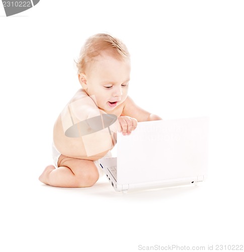 Image of baby boy in diaper with laptop computer