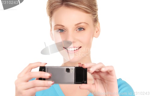 Image of happy woman using phone camera