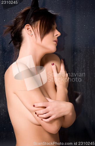 Image of woman with cat ears at the rainy window