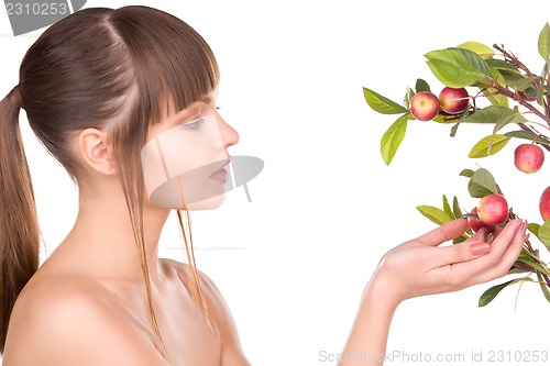 Image of lovely woman with apple twig