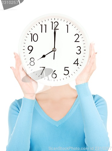 Image of woman with big clock covering face