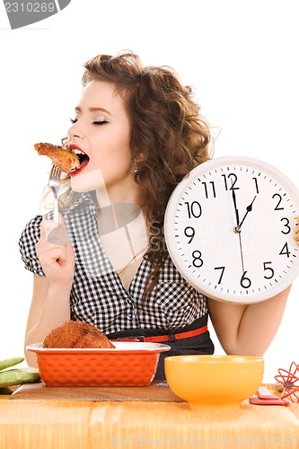 Image of young attractive woman in the kitchen