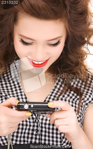 Image of happy teenage girl with digital camera