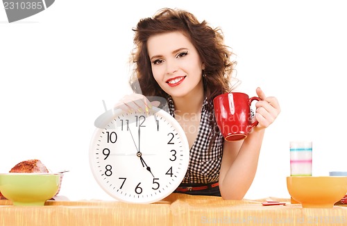 Image of young attractive woman in the kitchen