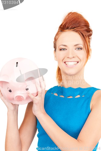 Image of lovely woman with piggy bank