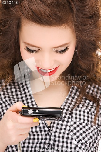 Image of happy teenage girl with digital camera