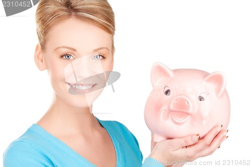 Image of lovely woman with piggy bank