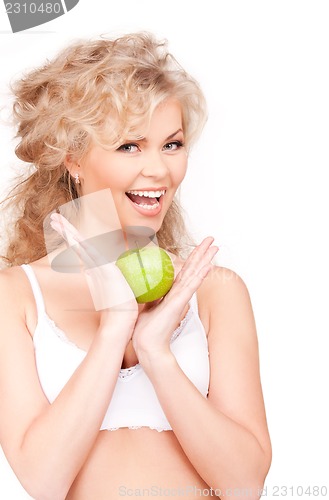 Image of young beautiful woman with green apple