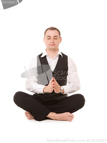 Image of businessman sitting in lotus pose