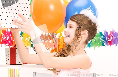 Image of party girl with balloons and gift box