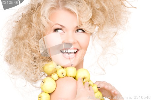 Image of happy woman with green apples