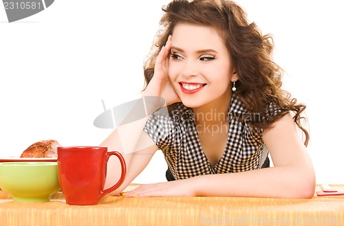 Image of young attractive woman in the kitchen