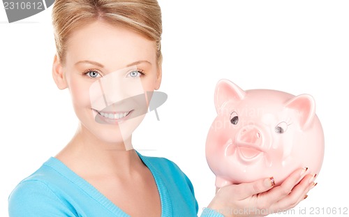 Image of lovely woman with piggy bank