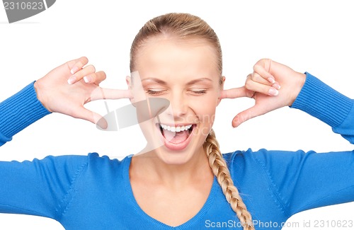 Image of smiling woman with fingers in ears