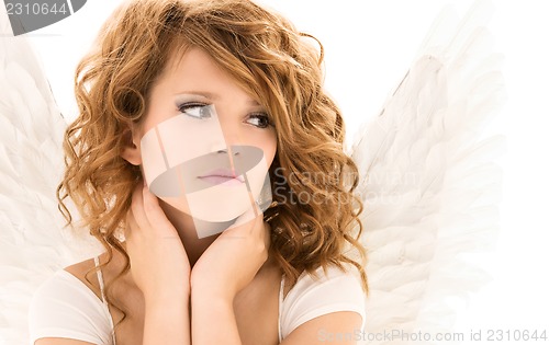 Image of unhappy teenage angel girl over white