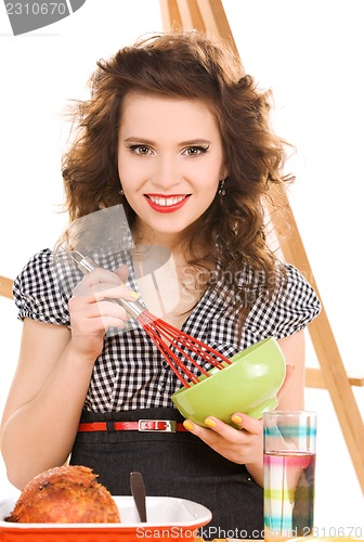 Image of young attractive woman in the kitchen