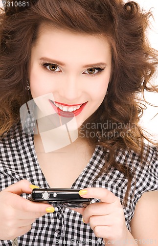 Image of happy teenage girl with digital camera
