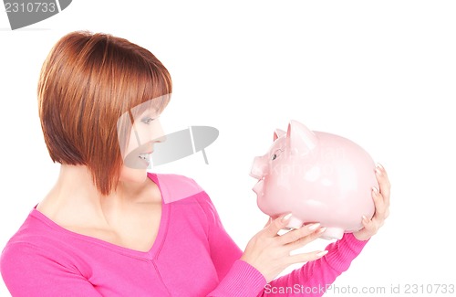 Image of lovely woman with piggy bank  
