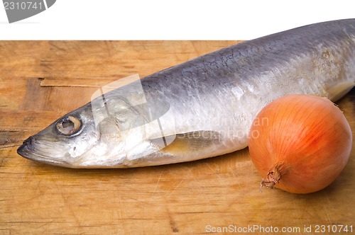 Image of Herring with onion on old wooden cutting board