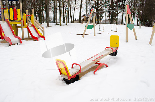 Image of empty playground swing childhood snow winter 