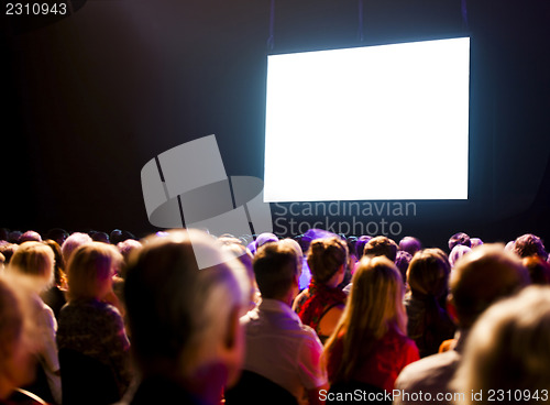 Image of Crowd audience looking at screen