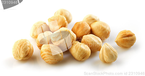 Image of Closeup view of hazelnuts over white background