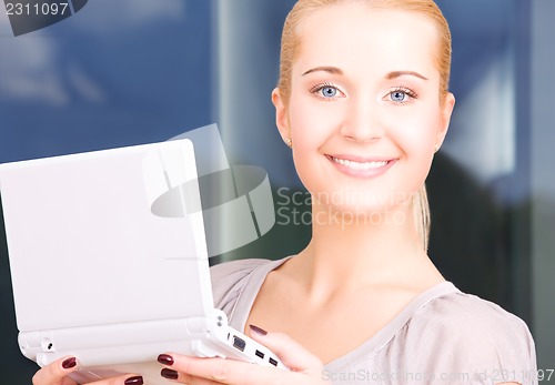 Image of happy businesswoman with laptop computer