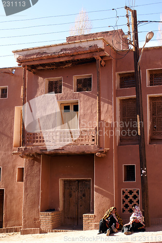 Image of Two women near house