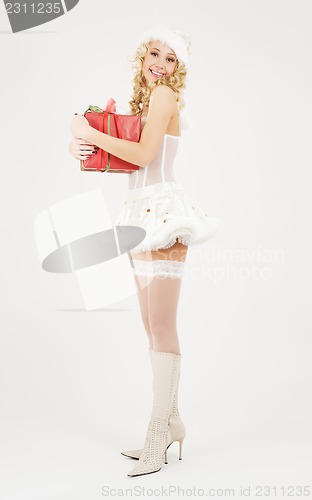 Image of cheerful santa helper girl with gift box