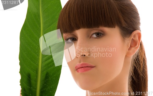 Image of woman with green leaf