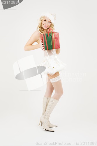 Image of cheerful santa helper girl with gift box