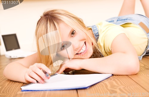 Image of teenage girl with notebook and pen