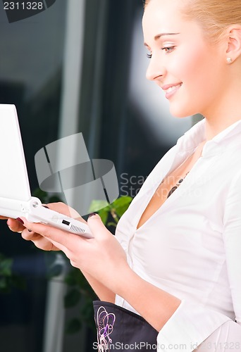 Image of happy businesswoman with laptop computer