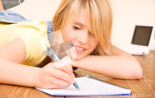 Image of teenage girl with notebook and pen