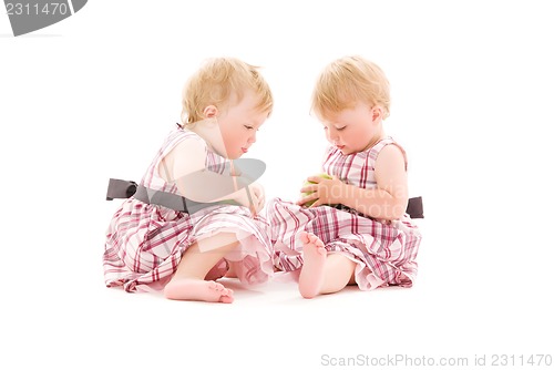 Image of two adorable twins over white