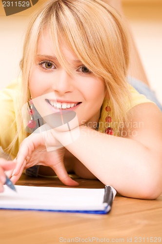 Image of teenage girl with notebook and pen